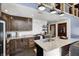 Charming kitchen features granite counters, dark wood cabinets, subway tile backsplash, and modern appliances at 7143 W 50 S, Morgantown, IN 46160