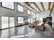 Bright and airy living room with high ceilings, large windows, and stylish leather furniture with polished concrete floors at 7143 W 50 S, Morgantown, IN 46160