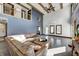 Spacious living room featuring a loft area, vaulted ceiling, exposed beams, and stylish leather furniture at 7143 W 50 S, Morgantown, IN 46160