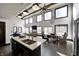 Bright living room boasts a wall of windows, exposed beams, modern lighting, open to the kitchen and dining areas at 7143 W 50 S, Morgantown, IN 46160