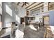 Spacious living room boasts high ceilings, exposed beams, modern lighting, and an open kitchen and dining area at 7143 W 50 S, Morgantown, IN 46160