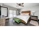 Comfortable main bedroom featuring a tufted headboard, stylish furniture, and access to outdoor space at 7143 W 50 S, Morgantown, IN 46160