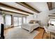 Inviting bedroom with exposed beams, a large window, and sliding glass doors for natural light and easy outdoor access at 7143 W 50 S, Morgantown, IN 46160