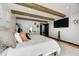 Cozy bedroom with exposed wood beams, a vanity, and a mounted TV offers comfort and style in a tranquil setting at 7143 W 50 S, Morgantown, IN 46160