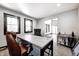 Bright home office featuring natural light, modern desk, and cozy seating area at 7143 W 50 S, Morgantown, IN 46160
