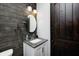 Chic powder room featuring a modern vanity, sleek mirror, and rustic wood paneling at 7143 W 50 S, Morgantown, IN 46160