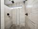 Sleek shower room features updated shower heads and tiled walls at 7143 W 50 S, Morgantown, IN 46160