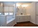Elegant bathroom features a soaking tub, double vanity sinks, and stylish lighting fixtures at 7195 Koldyke Dr, Fishers, IN 46038