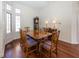 Formal dining room with hardwood floors, a large dining table, and a bay window at 7195 Koldyke Dr, Fishers, IN 46038