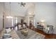Open-concept living room featuring hardwood floors, fireplace, and natural light at 7195 Koldyke Dr, Fishers, IN 46038
