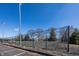 Community tennis court surrounded by trees and parking spaces, offering a recreational amenity at 7195 Koldyke Dr, Fishers, IN 46038