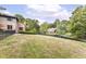 Expansive backyard bordered by a fence, featuring a view of the home and the tranquil pond at 7645 Ballinshire N, Indianapolis, IN 46254