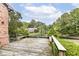 Scenic backyard with wooden deck, landscaping and a peaceful pond view creating a serene outdoor oasis at 7645 Ballinshire N, Indianapolis, IN 46254