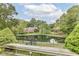 Picturesque backyard featuring a tranquil pond view from the wooden deck, surrounded by lush greenery at 7645 Ballinshire N, Indianapolis, IN 46254