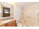 Clean bathroom with updated vanity, a white tiled shower-tub combo, and a large mirror at 7645 Ballinshire N, Indianapolis, IN 46254
