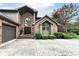 A brick home with an arched window above the front door and a three-car garage on a concrete driveway at 7645 Ballinshire N, Indianapolis, IN 46254