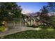 Charming brick home featuring a three-car garage and well-maintained landscaping, and a beautiful lawn at 7645 Ballinshire N, Indianapolis, IN 46254
