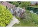 Aerial view of home featuring mature trees, landscaped garden beds, and a driveway at 7645 Ballinshire N, Indianapolis, IN 46254