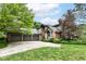 Charming brick home featuring a three-car garage and well-maintained landscaping, and a beautiful lawn at 7645 Ballinshire N, Indianapolis, IN 46254