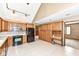 Kitchen featuring oak cabinets, tile flooring, and black appliances at 7645 Ballinshire N, Indianapolis, IN 46254