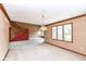 Open living room featuring staircase, bright windows, and neutral colored carpet at 7645 Ballinshire N, Indianapolis, IN 46254