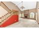 Open living room featuring a brick fireplace, vaulted ceilings and a staircase at 7645 Ballinshire N, Indianapolis, IN 46254
