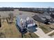 This aerial view showcases a beautiful home with a spacious yard and three car garage at 7675 Winding Lake S Dr, Noblesville, IN 46062