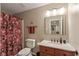 Neutral-toned bathroom featuring a shower with curtain, vanity with granite, and a large mirror at 7675 Winding Lake S Dr, Noblesville, IN 46062