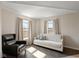 Bright bedroom area featuring a large window, hardwood floors, neutral walls, and natural lighting at 7675 Winding Lake S Dr, Noblesville, IN 46062