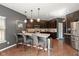 This spacious kitchen boasts modern pendant lighting, stainless steel appliances, and an eat-in breakfast bar at 7675 Winding Lake S Dr, Noblesville, IN 46062