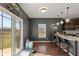 Bright eat-in kitchen features a breakfast bar, stainless steel appliances, and sliding glass doors to the backyard at 7675 Winding Lake S Dr, Noblesville, IN 46062