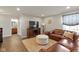 Comfortable living room features a leather sectional sofa, neutral decor, and an adjacent bathroom at 7675 Winding Lake S Dr, Noblesville, IN 46062