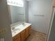Bathroom featuring double sinks, tile floor, and wood cabinets at 777 West St, Whiteland, IN 46184
