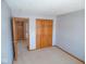 Cozy bedroom with wall to wall carpet, double door closet and entryway to next room at 777 West St, Whiteland, IN 46184