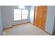 Neutral bedroom featuring carpet, light-filled window and a double door closet at 777 West St, Whiteland, IN 46184