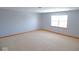 Bright bedroom with neutral carpet and trim and big window at 777 West St, Whiteland, IN 46184