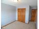 Bedroom featuring wall to wall carpet, double door closet and an entryway to another room at 777 West St, Whiteland, IN 46184