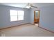 This large bedroom features carpet, bright window, and en suite bath at 777 West St, Whiteland, IN 46184