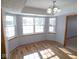 Bright dining room with laminate floors, a modern chandelier, and several windows offering a beautiful view at 777 West St, Whiteland, IN 46184