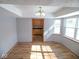 Bright dining room with wood floors, updated chandelier, and a view into the kitchen at 777 West St, Whiteland, IN 46184