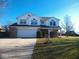 Charming two-story home with brick accents, a two-car garage, and a well-manicured front lawn at 777 West St, Whiteland, IN 46184