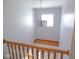 Bright landing featuring wood railing, modern chandelier, and window at 777 West St, Whiteland, IN 46184