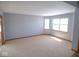 Spacious living room featuring neutral carpeting, with ample natural light from large windows at 777 West St, Whiteland, IN 46184
