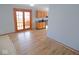 Open-concept living area with laminate flooring and french doors leading to an outdoor space at 777 West St, Whiteland, IN 46184
