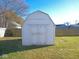 White shed with barn doors in the backyard offering convenient storage space at 777 West St, Whiteland, IN 46184
