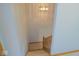 Carpeted staircase with wood railing and decorative lighting at 777 West St, Whiteland, IN 46184