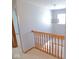 Staircase with wooden railings leading to the upper level, illuminated by a modern chandelier at 777 West St, Whiteland, IN 46184