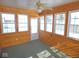 Cozy sun room with wood paneling and multiple windows that flood the space with natural light at 777 West St, Whiteland, IN 46184