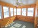 Inviting sun room with wood walls, a ceiling fan, and several windows offering a bright and airy atmosphere at 777 West St, Whiteland, IN 46184