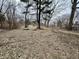Large open backyard with patchy ground and bare trees at 8328 S Franklin Rd, Indianapolis, IN 46259